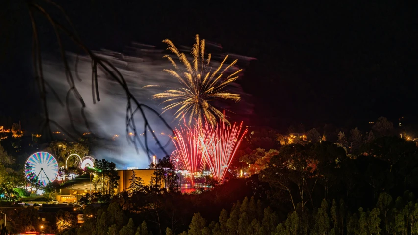 fireworks are going off in the sky above some trees