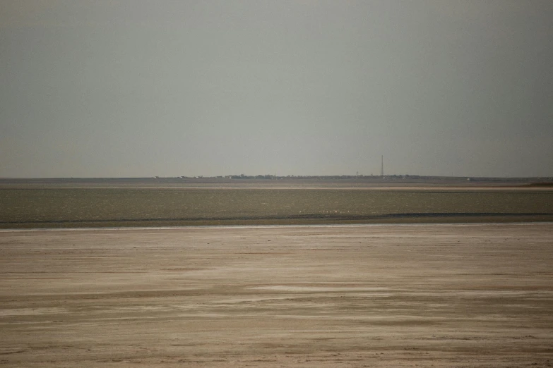 an airplane is flying over the vast desert