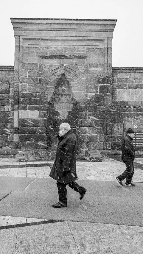 a man is walking in the snow outside