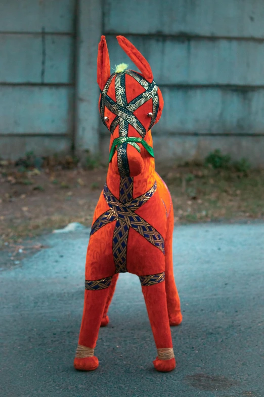 a plush animal with some kind of tied string on its back