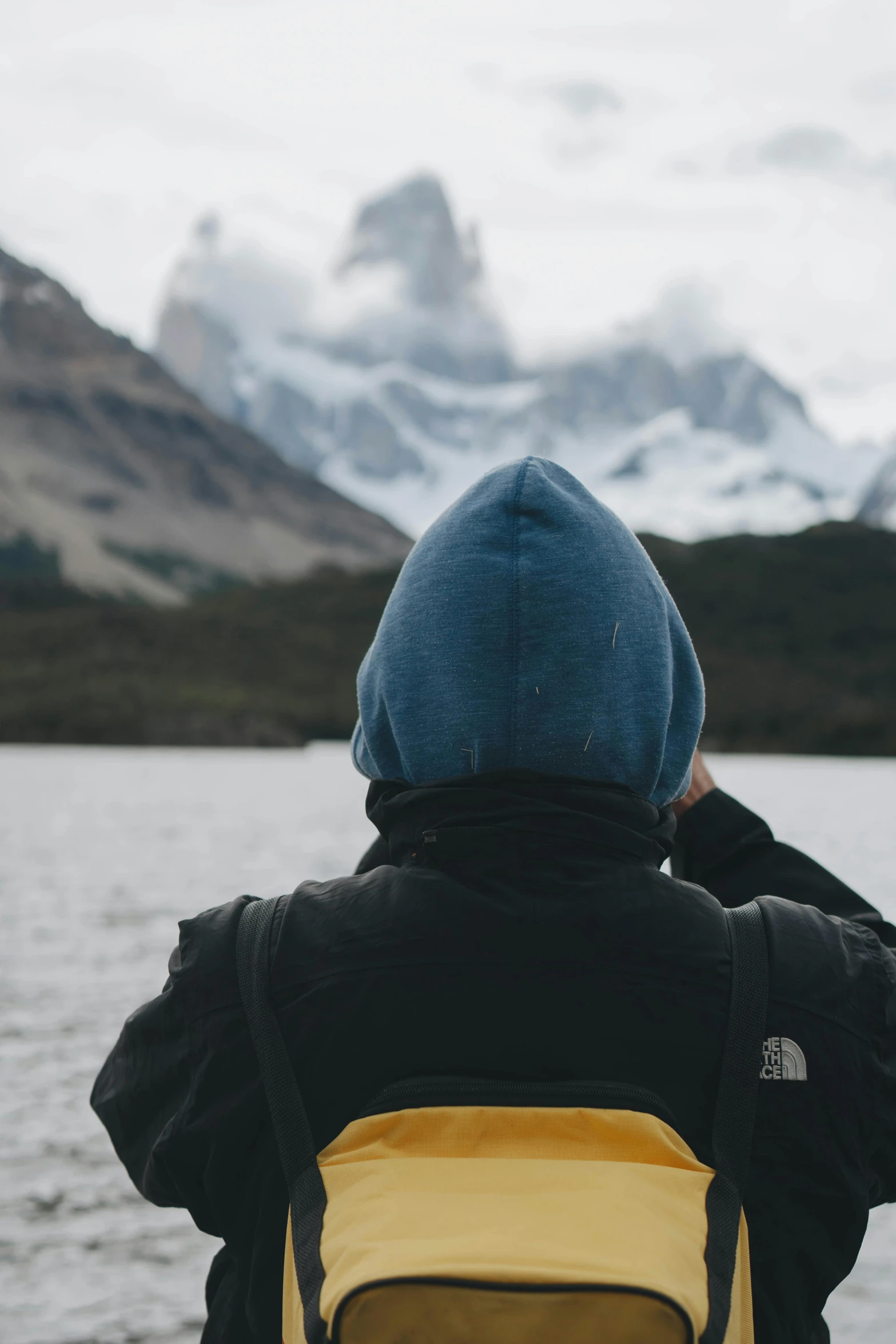 a young child is looking at a mountain range