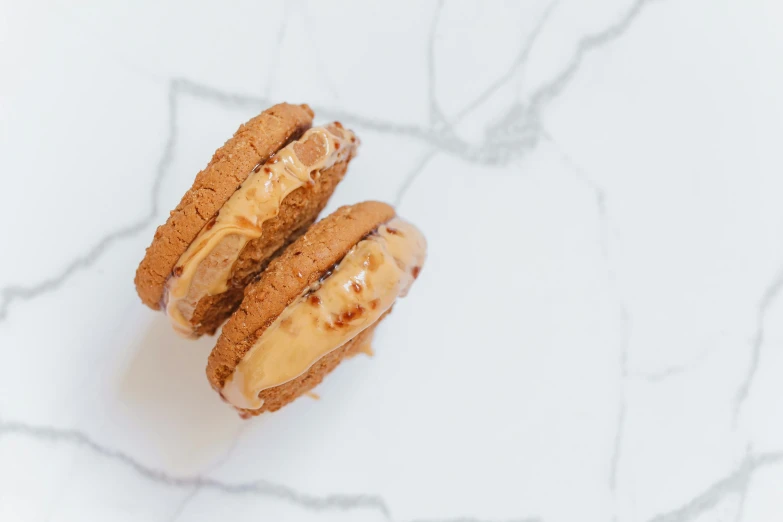 two cookies with peanut er on each