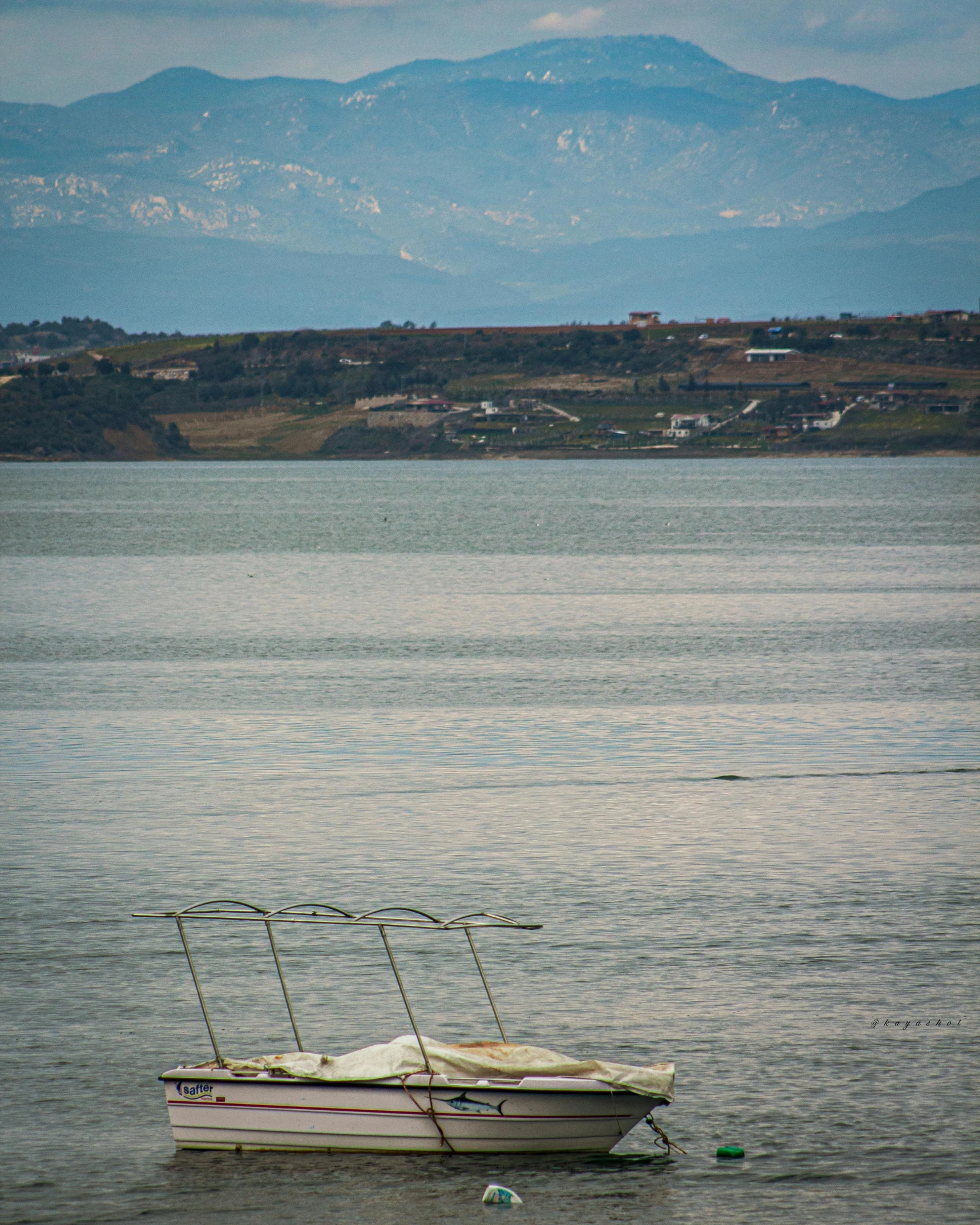 a boat is floating on the calm water