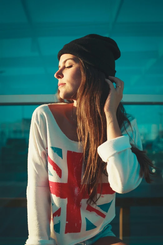 a girl with long hair sitting down holding a phone