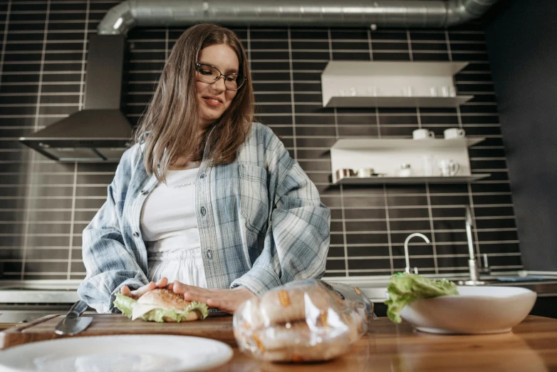 a woman standing in front of a counter with food