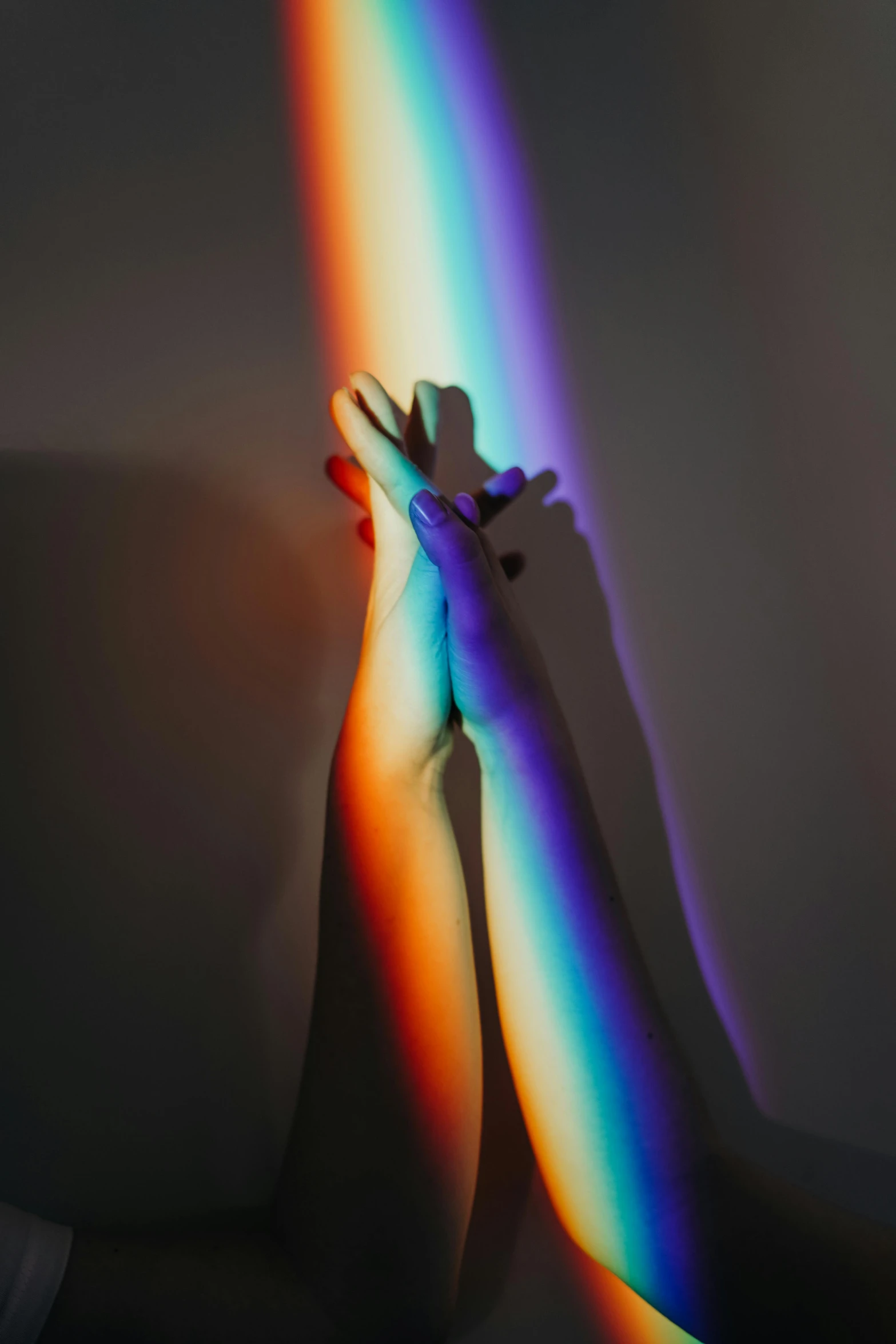 a person standing over a white wall with rainbow