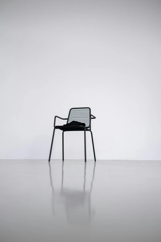 the modern looking chair is set against a wall