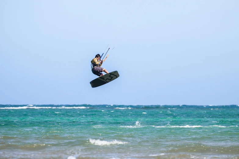 the guy is enjoying his water sports high above the waves