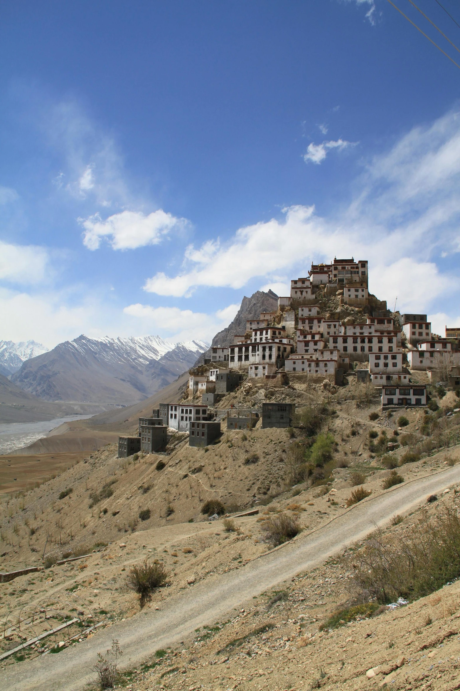 a desert area with a group of buildings on top