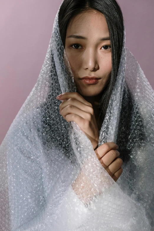 an asian woman wearing a veil over her head