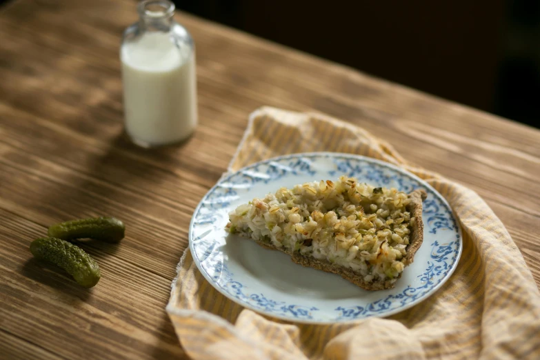 an oatmeal dessert on a plate next to some sour cream