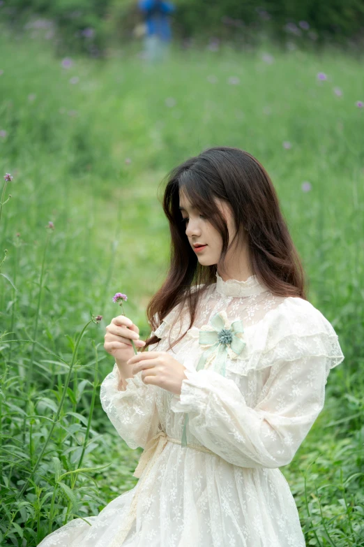 the woman is posing in her dress and holding flowers