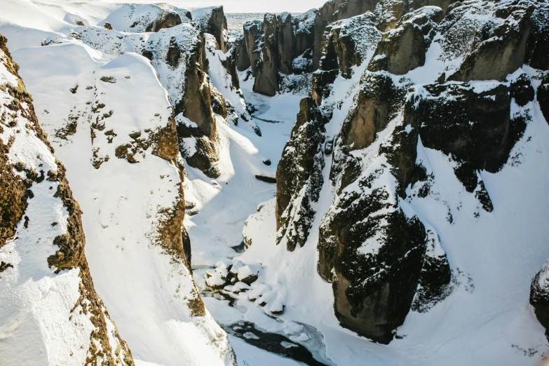 a snow covered canyon near an alpine mountain