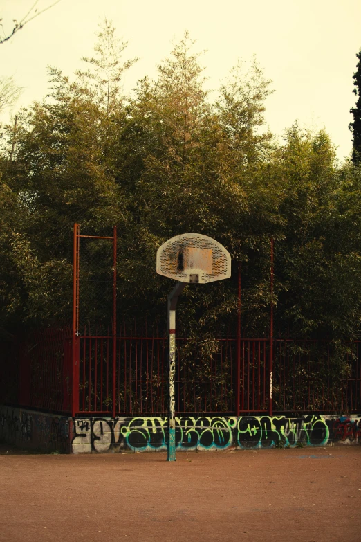 a basketball hoop on the side of a road