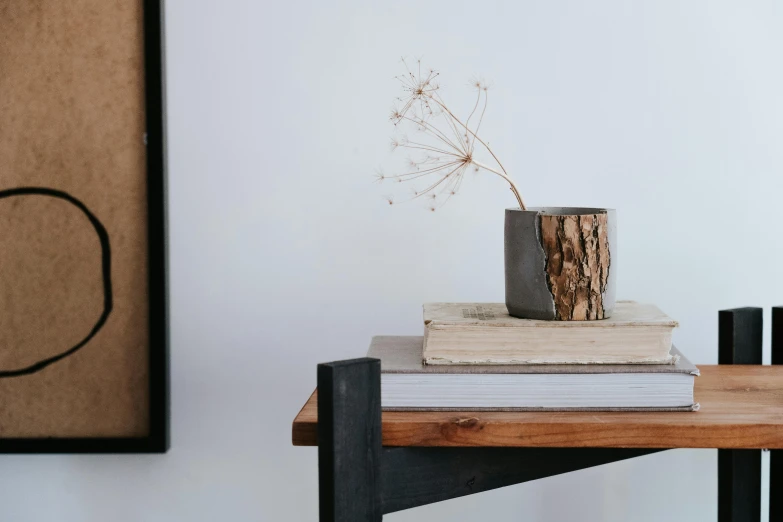 a vase that is on top of a stack of books