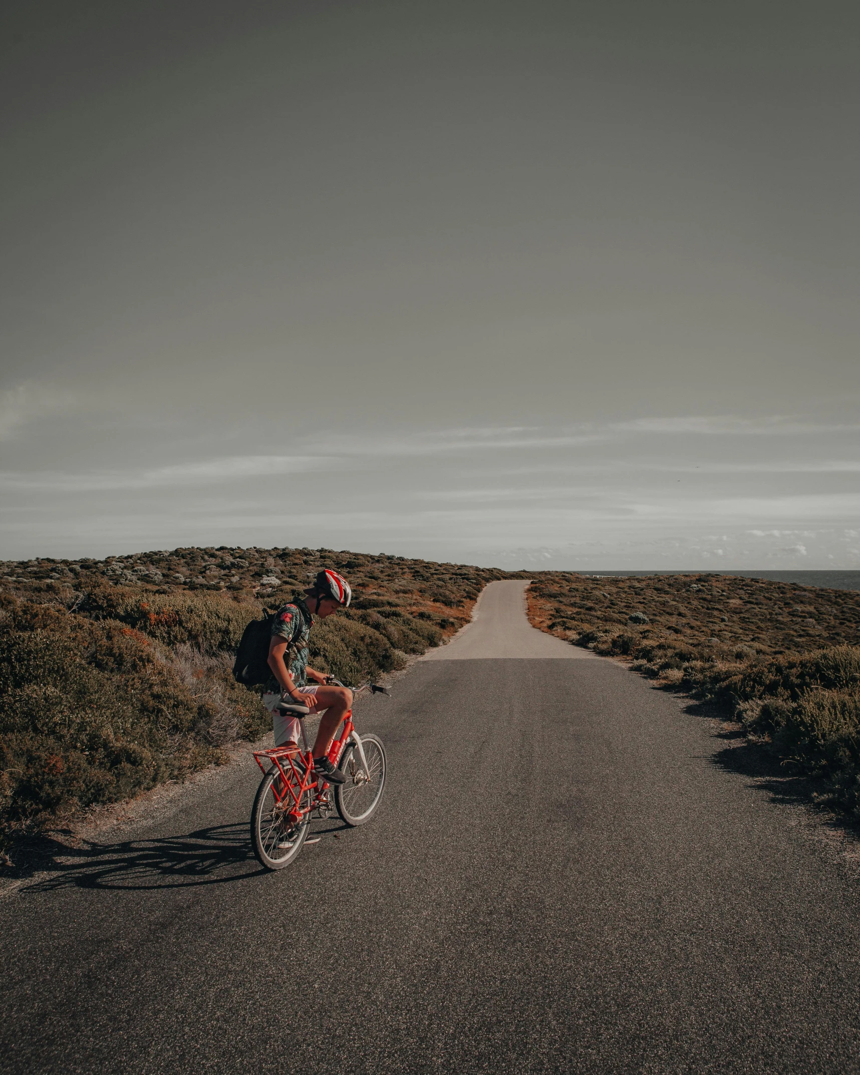 the man is riding his bike down the road