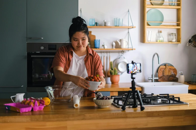 a woman preparing food on top of a wooden counter