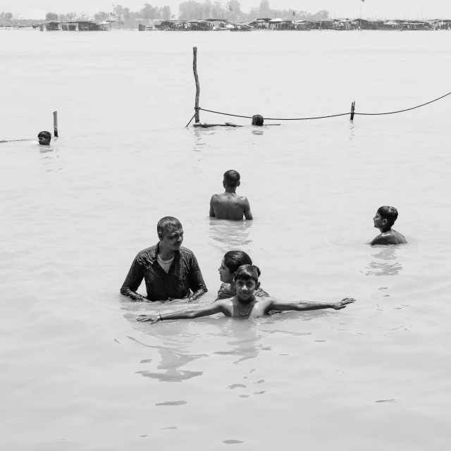 six people in the water at a lake