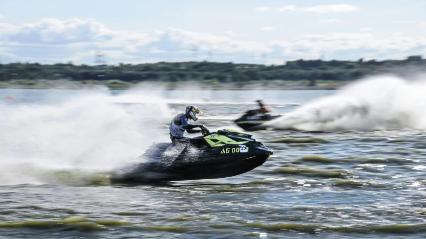 a couple of people riding jet skis on top of a lake