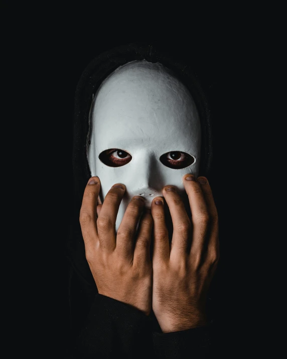a person wearing a white mask covering their face