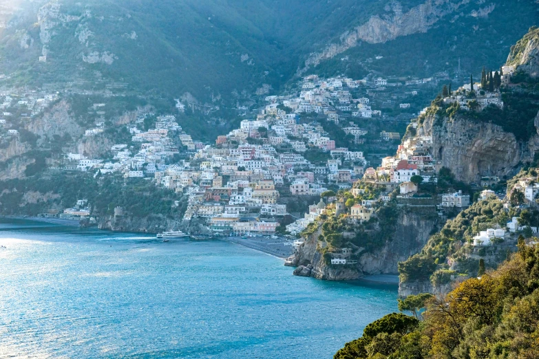 a body of water with houses on a hill and a city