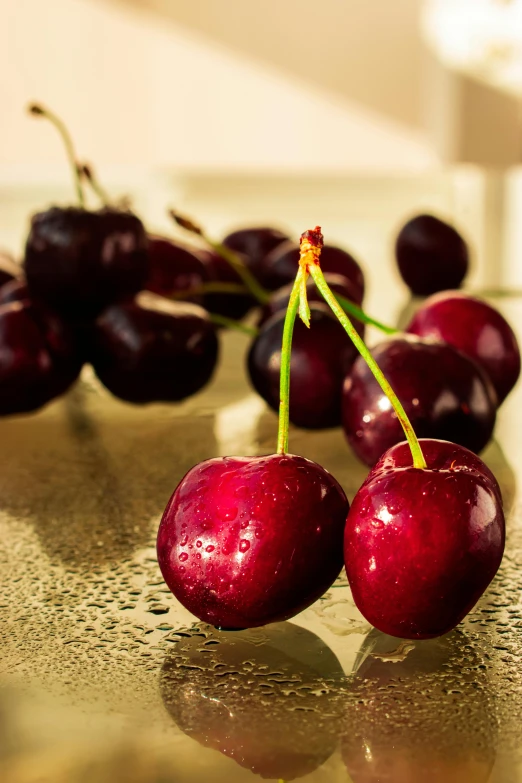 a couple of cherries sitting on top of a table