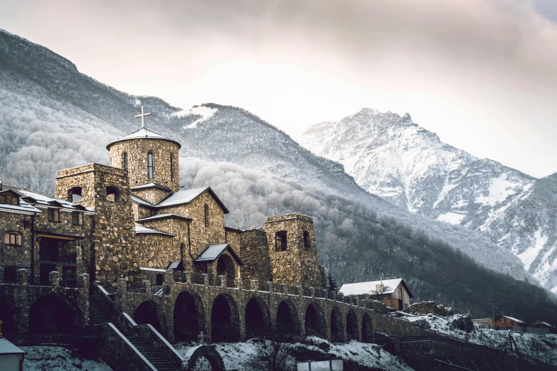 a church with a cross sitting on the side of it