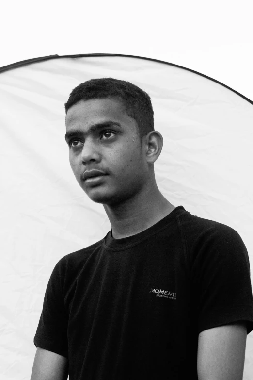 a young man with black t - shirt and white sheet