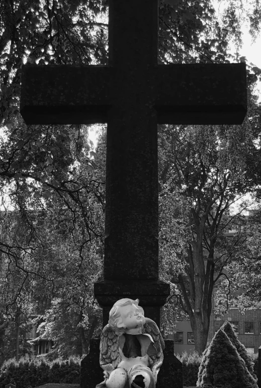 a graveyard with a big cross behind it