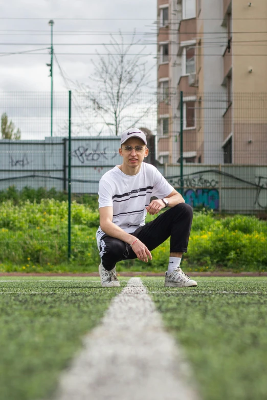 a man sitting on a line with his shoe off