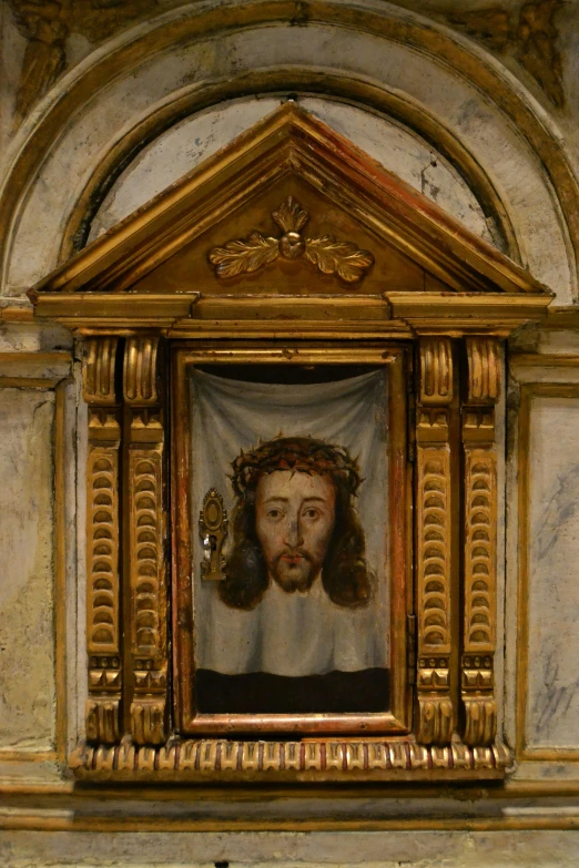 painting of bearded man in a gold frame