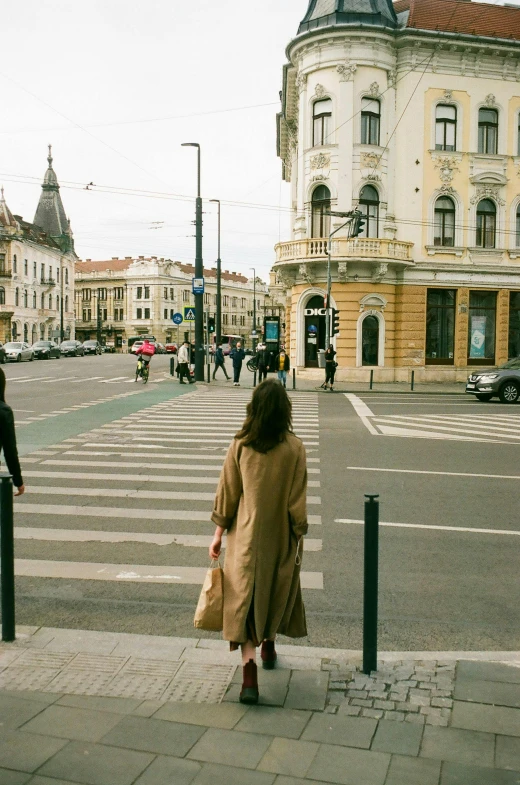 a woman is walking in the middle of the street