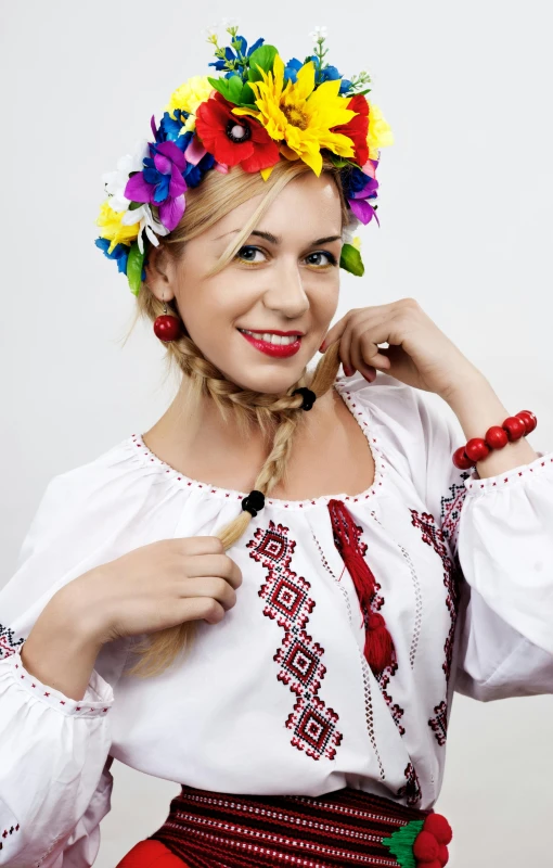 a woman dressed in traditional hungarian clothing posing for a portrait