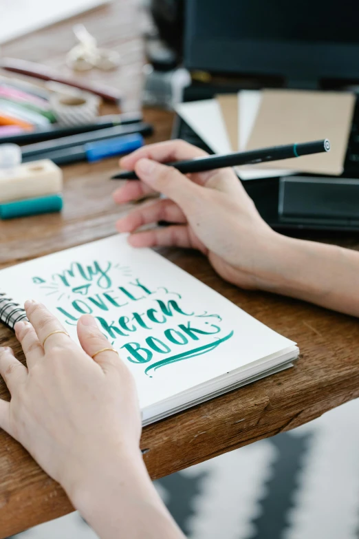 a person doing a handwritten quote in a notebook