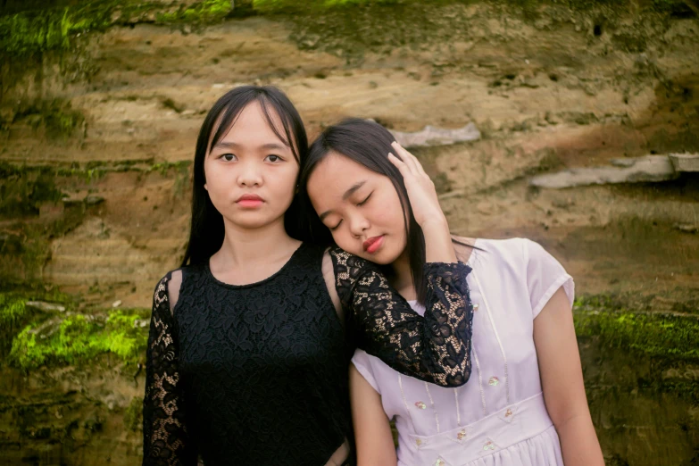 two young women are standing near each other