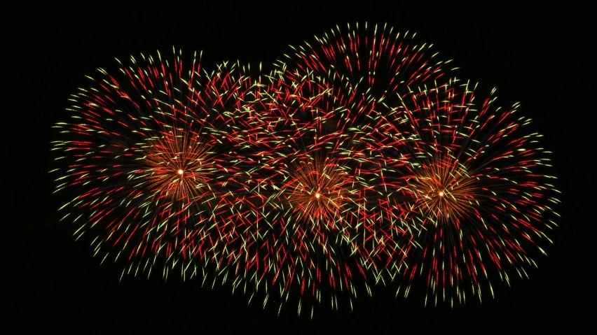 a large display of fireworks at night with bright lights