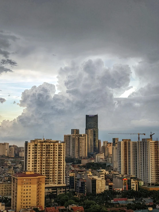 a city beneath cloudy skies with clouds over it