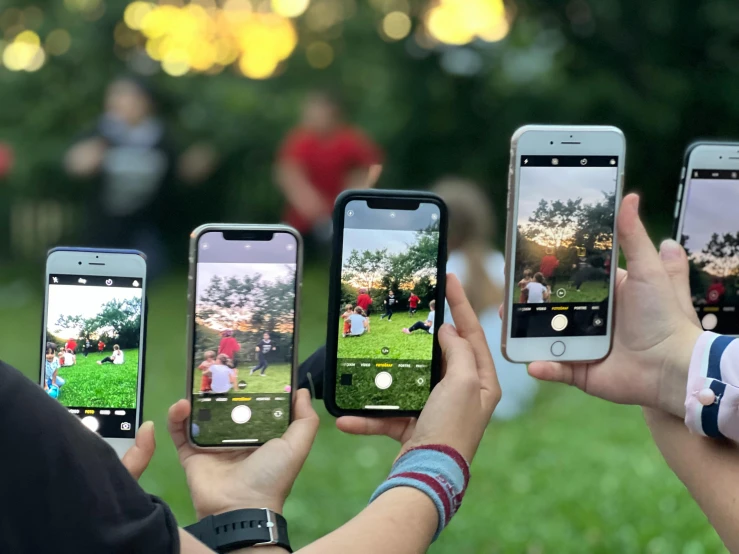 people are holding up different types of cellphones