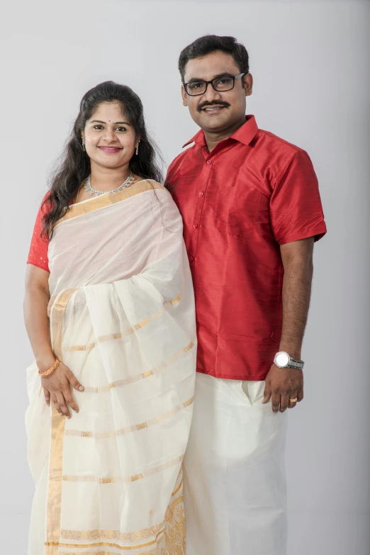 a man and woman in red posing together