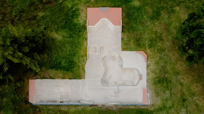 an aerial view of a white home with green trees