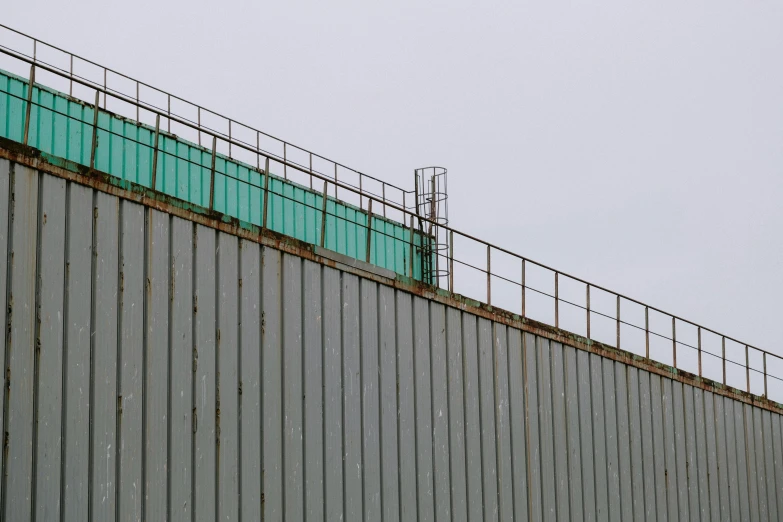 a view of a building with metal fenced walls