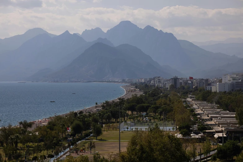 view of a city with water and mountains in the background