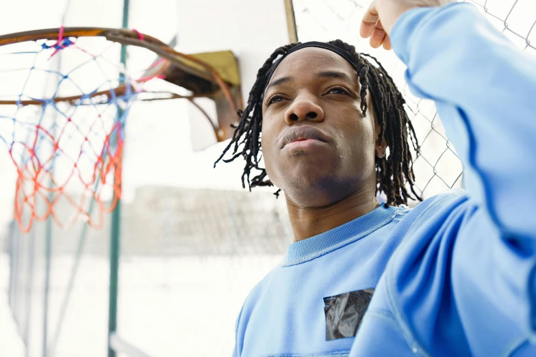 a man standing in front of a net holding his finger