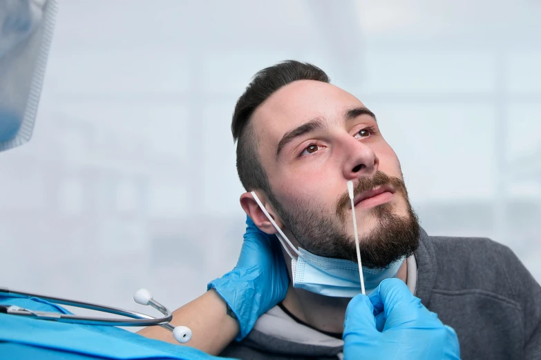 a man is doing his teeth whitening on his face