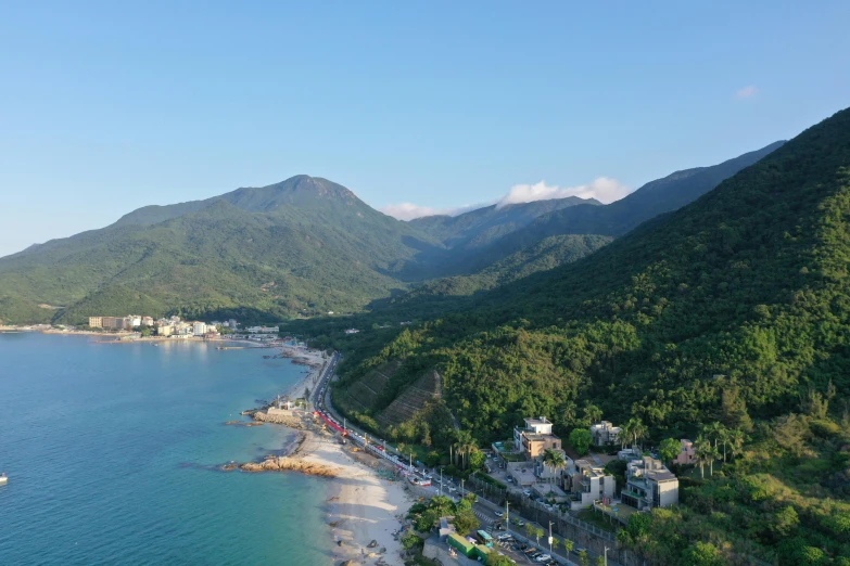 the beach sits near many trees and hills