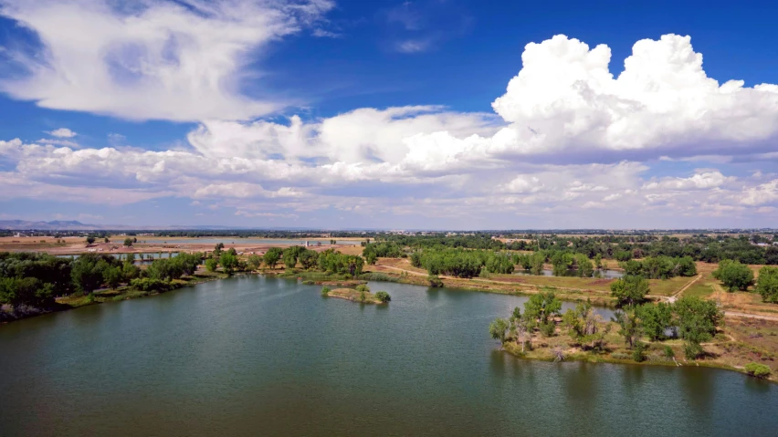 a small island on a lake in the middle of an empty field