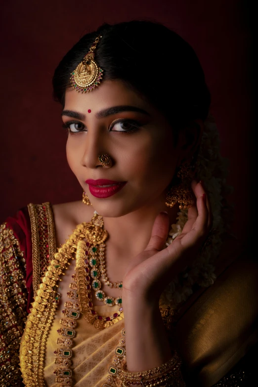 a woman with gold jewelry on her face