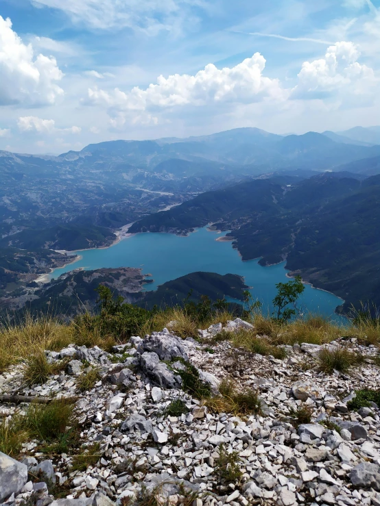 a view from atop a hill looking down at water