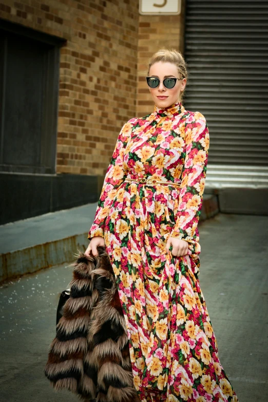 a woman walking down the street with a fur bag