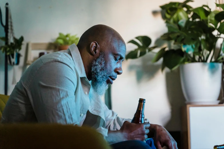 a man is holding a beer in his hands